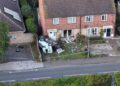 Emergency services at the scene in Paston Ridings, Peterborough, after a car crashed into a semi-detached house and overturned beside a parked vehicle.