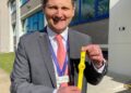 Detective Chief Inspector Dave Savill with some of the yellow dementia safeguarding wristbands being used across Cambridgeshire.