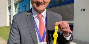 Detective Chief Inspector Dave Savill with some of the yellow dementia safeguarding wristbands being used across Cambridgeshire.