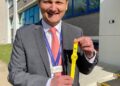 Detective Chief Inspector Dave Savill with some of the yellow dementia safeguarding wristbands being used across Cambridgeshire.