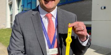 Detective Chief Inspector Dave Savill with some of the yellow dementia safeguarding wristbands being used across Cambridgeshire.
