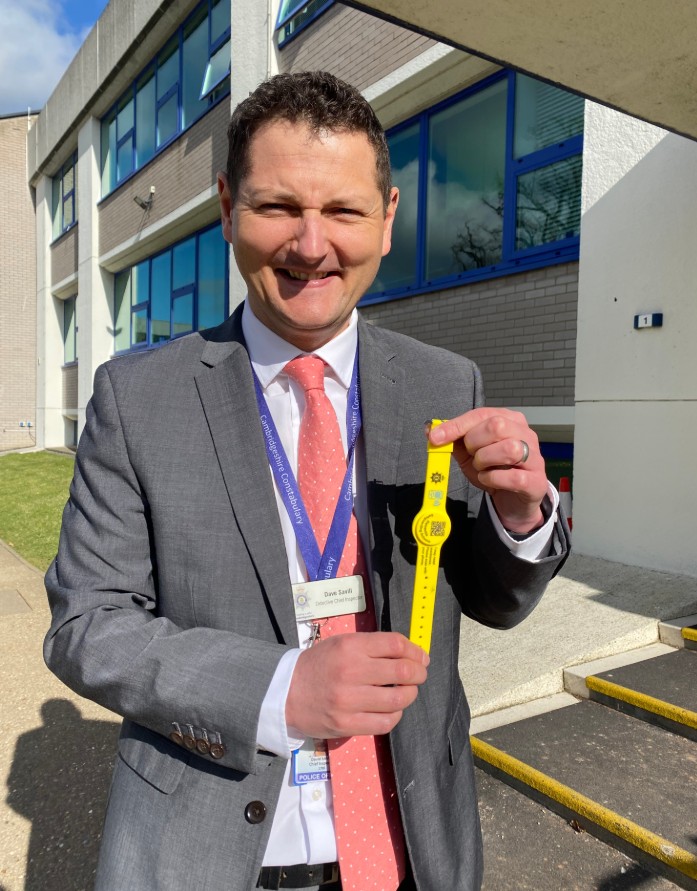 Detective Chief Inspector Dave Savill with some of the yellow dementia safeguarding wristbands being used across Cambridgeshire.