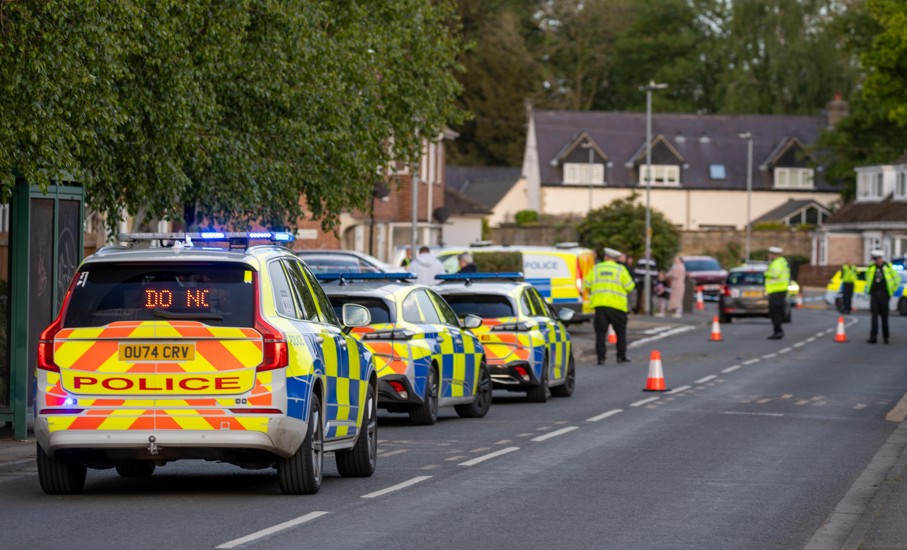Police officers and paramedics respond after a Ford Mondeo crashed into a house and parked vehicles in Peterborough. Photo: Terry Harris/CambsNews