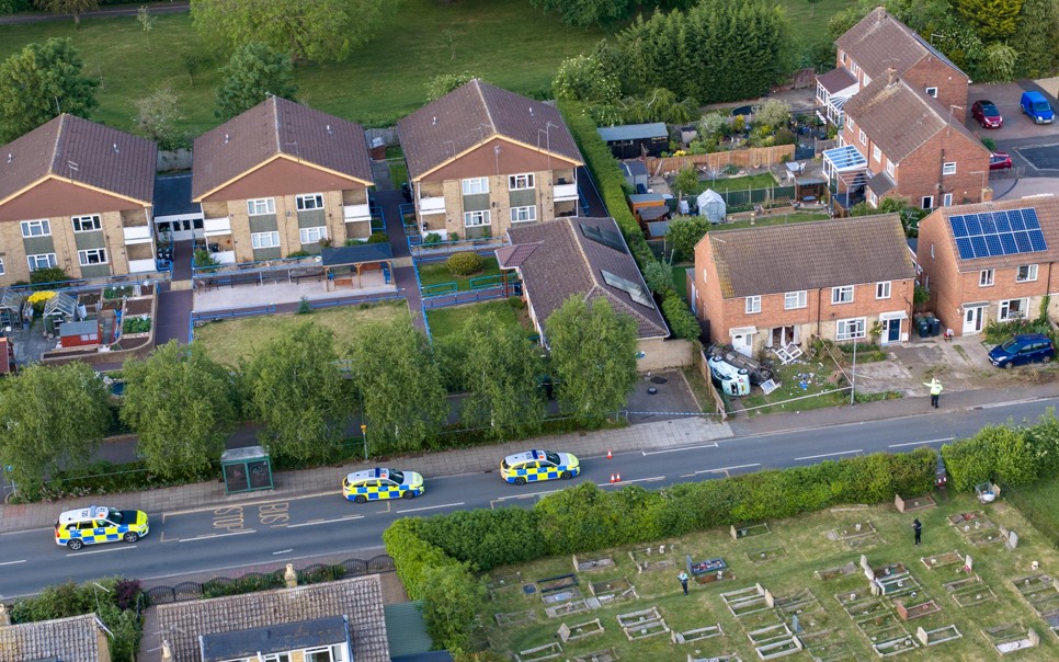Police officers and paramedics respond after a Ford Mondeo crashed into a house and parked vehicles in Peterborough. Photo: Terry Harris/CambsNews