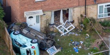 Extensive damage is seen after a blue Ford Mondeo crashed into a house in Paston Ridings, Peterborough, leaving two people seriously injured. Photo: Terry Harris/CambsNew