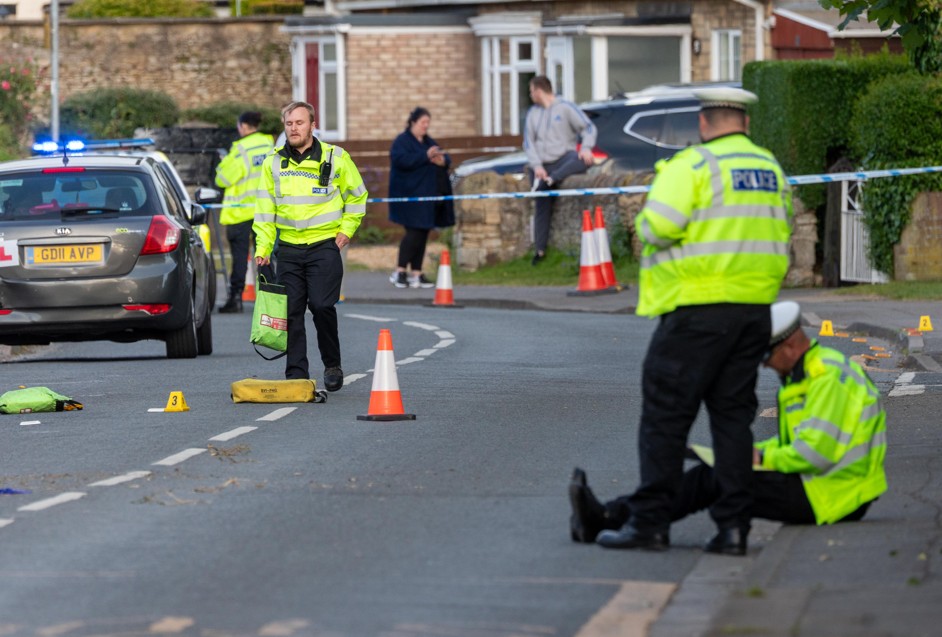 Police officers and paramedics respond after a Ford Mondeo crashed into a house and parked vehicles in Peterborough. Photo: Terry Harris/CambsNews