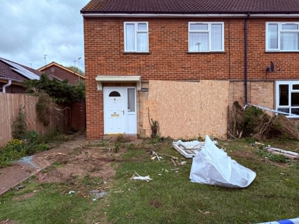 The damaged house in Paston Ridings, Peterborough, boarded up a day after a Ford Mondeo crashed into the property leaving two people seriously injured. Photo: Terry Harris/CambsNews
